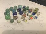 AN INTERESTING COLLECTION OF THIRTY ANTIQUE GLASS MARBLES.