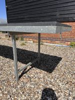 Large galvanised metal horticultural benches with raised edge open base