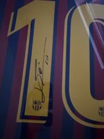 Framed signed Lionel Messi jersey