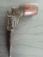 This item is a vintage smoking pipe designed to resemble a French revolver.