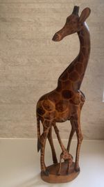 hand-carved wooden giraffe figurine, often featured in African-themed decor 60cm