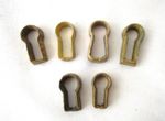 A SELECTION OF SIX ORIGINAL ANTIQUE BRASS KEY HOLE DRAWER INSERT / ESCUTCHEONS.