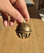 Vintage Indian brass elephant claw bell featuring hand-etched floral patterns