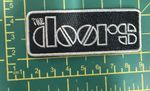 The Doors Bordered Logo Woven Sew Or Iron On Oblong Patch Officially Licensed