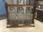 QUALITY GENTLEMEN’S  ANTIQUE  SOLID OAK CASED,THREE BOTTLE TANTALUS  CIRCA 1910.