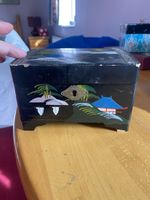 A 1950s Japanese Wood Hand Painted Black Lacquer Musical Jewellery Box