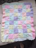 Hand Knitted Baby Blanket in baby pastels with a lace effect knitted border