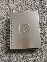 Photograph album 14x17cm. Silver coloured cover. Holds 48 photos