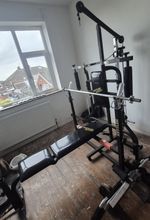 Kettler multi gym with bench press, bar, lat pull down bar and cast iron weights