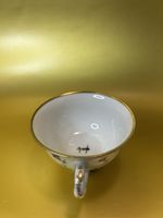 Vintage porcelain teacup featuring a floral pattern, designed in the Nyon style.