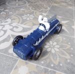 Cast Iron " MICHELIN MAN In Blue Racing Car " 10 inches long