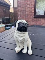 white and black Pochy brand resin pug statue