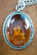 ANTIQUE AMBER & SILVER PENDANT WITH A REPOUSSE POLO PLAYER + SILVER 22" CHAIN