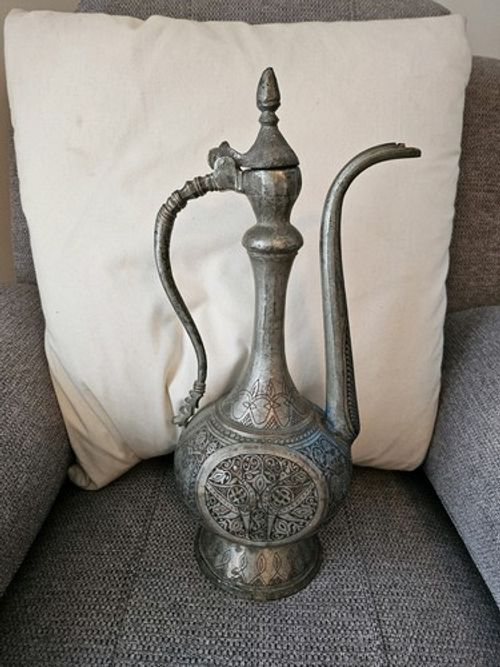 An Antique Middle Eastern Silvered Copper Ewer with Etched Design