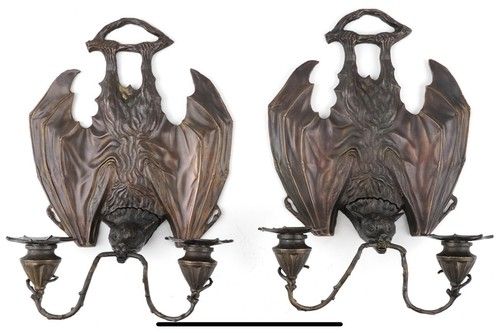 A pair of Art Nouveau style patinated bronze bat gothic design wall sconces